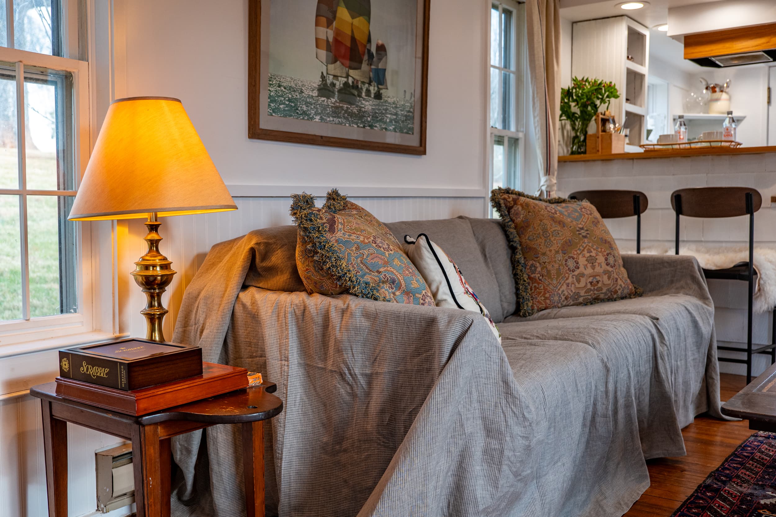 Couch with paisley pillows and vintage art