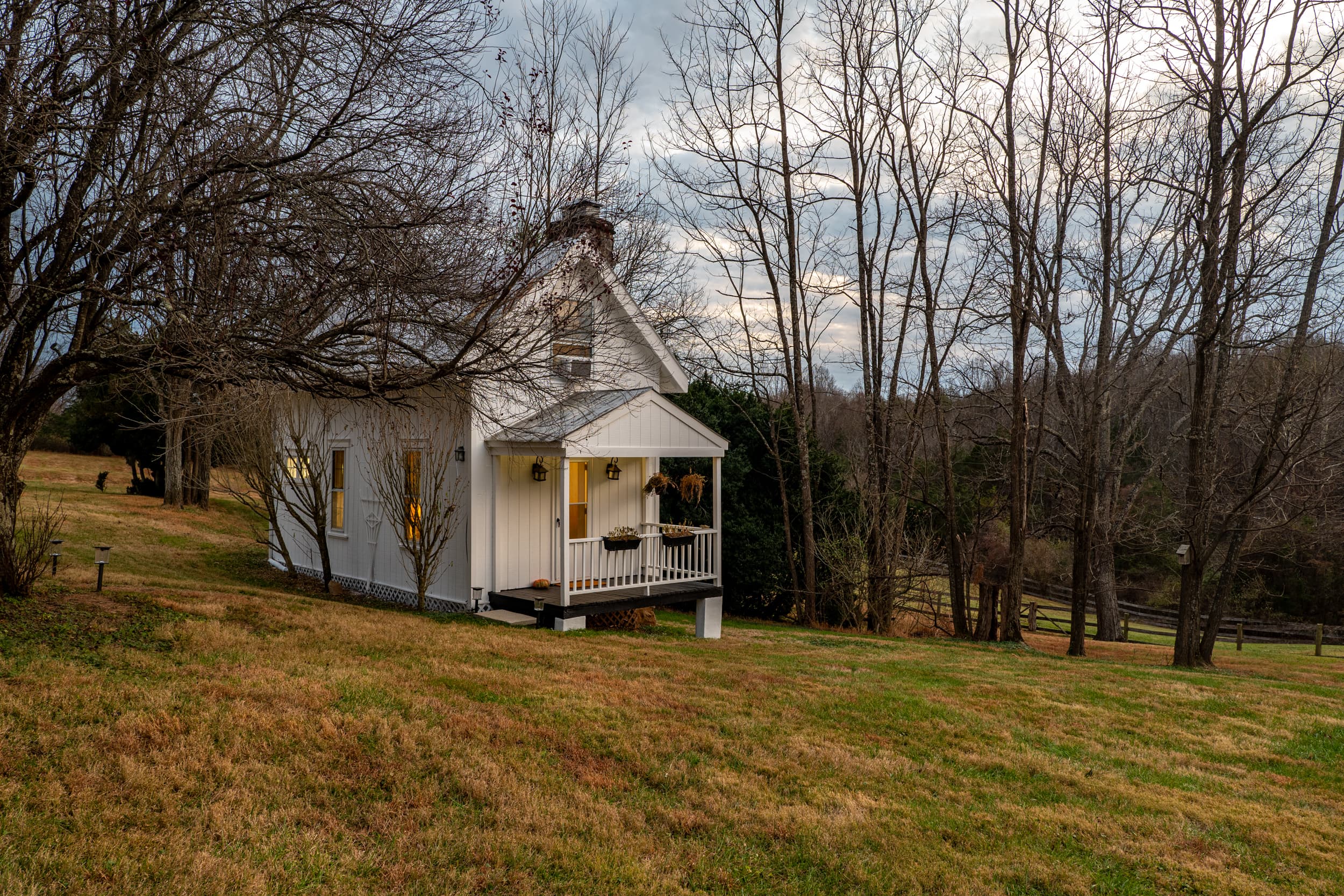 The Ingleside Farm cottage on a gentle hillside under a moody sky
